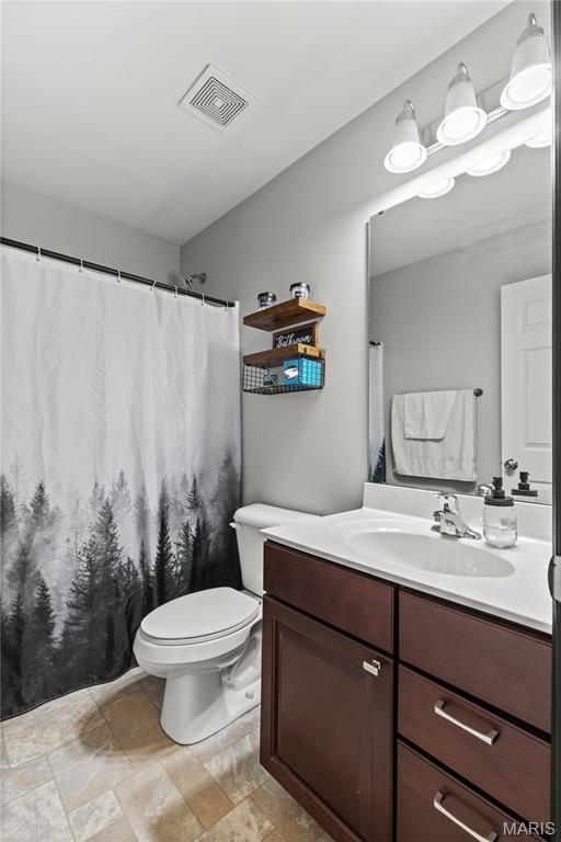 111 Rivers Edge Dr, Moscow Mills, MO 63362 - full bathroom with vanity and stone finish flooring