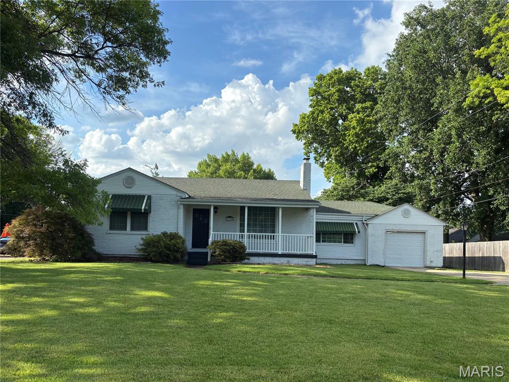 2125 Richmond Ave, Granite City, IL 62040 - ranch-style house featuring a porch, a chimney, and an attached garage