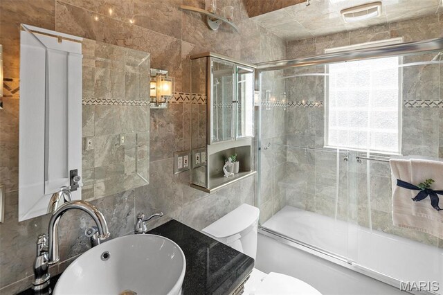 1110 Logan St, Alton, IL 62002 - bathroom featuring tile walls, bath / shower combo with glass door, and vanity