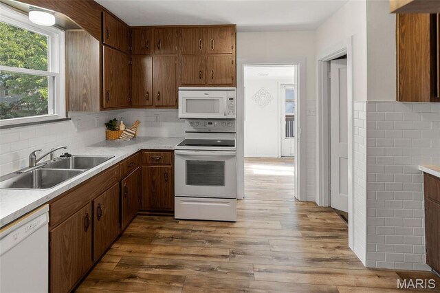 1110 Logan St, Alton, IL 62002 - kitchen featuring white appliances, light countertops, backsplash, and wood finished floors