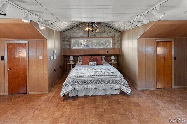 1110 Logan St, Alton, IL 62002 - bedroom featuring rail lighting, lofted ceiling, and wood walls