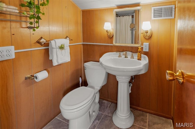 1110 Logan St, Alton, IL 62002 - bathroom with wood walls and tile patterned flooring