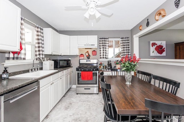 314 Weber Dr, Eureka, MO 63025 - kitchen with appliances with stainless steel finishes, under cabinet range hood, ceiling fan, white cabinets, and dark countertops