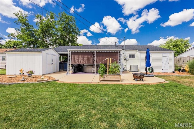 314 Weber Dr, Eureka, MO 63025 - back of house featuring a patio area, a shed, a fire pit, and roof with shingles