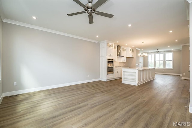 8915 E Gateway Hts Unit 94-803, Richmond Heights, MO 63144 - unfurnished living room with crown molding, a ceiling fan, recessed lighting, wood finished floors, and a chandelier