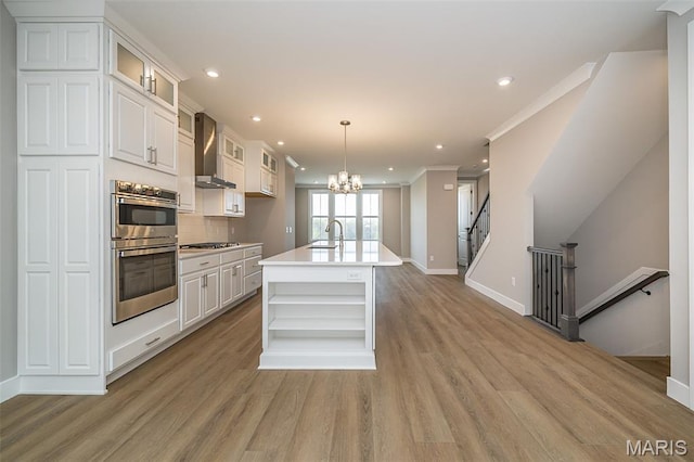 8915 E Gateway Hts Unit 94-803, Richmond Heights, MO 63144 - kitchen with stainless steel appliances, wall chimney exhaust hood, open shelves, recessed lighting, and a chandelier