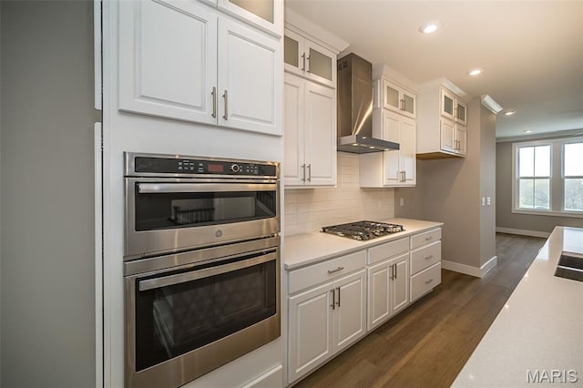8915 E Gateway Hts Unit 94-803, Richmond Heights, MO 63144 - kitchen featuring stainless steel appliances, wall chimney exhaust hood, light countertops, white cabinetry, and recessed lighting