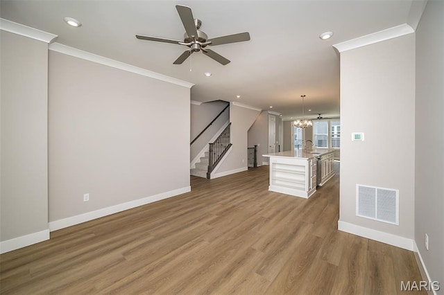 8915 E Gateway Hts Unit 94-803, Richmond Heights, MO 63144 - unfurnished living room with crown molding, wood finished floors, stairs, ceiling fan, and recessed lighting