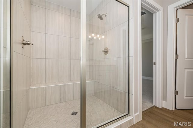 8915 E Gateway Hts Unit 94-803, Richmond Heights, MO 63144 - bathroom featuring a stall shower and wood finished floors