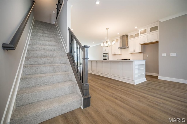 8915 E Gateway Hts Unit 94-803, Richmond Heights, MO 63144 - staircase featuring wood finished floors, recessed lighting, a chandelier, and a barn door