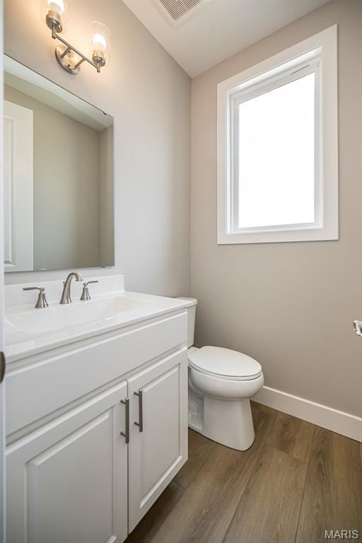 8915 E Gateway Hts Unit 94-803, Richmond Heights, MO 63144 - half bathroom featuring vanity and wood finished floors