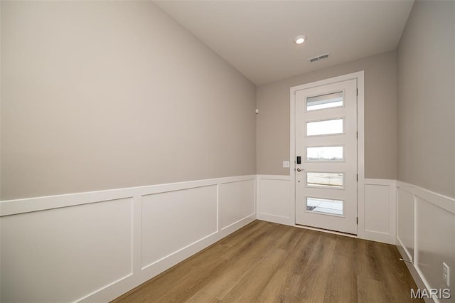 8915 E Gateway Hts Unit 94-803, Richmond Heights, MO 63144 - entryway featuring wood finished floors, wainscoting, a decorative wall, and recessed lighting