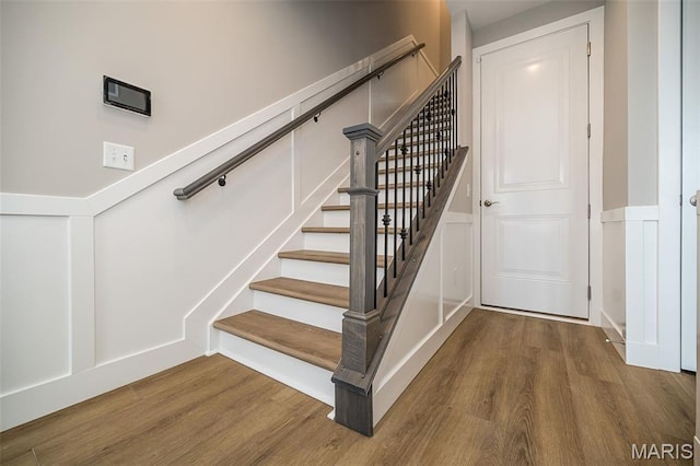 8915 E Gateway Hts Unit 94-803, Richmond Heights, MO 63144 - staircase with a decorative wall, wood finished floors, and a wainscoted wall