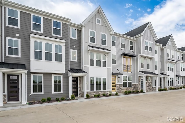 8915 E Gateway Hts Unit 94-803, Richmond Heights, MO 63144 - townhome / multi-family property with a standing seam roof, board and batten siding, stone siding, and a residential view