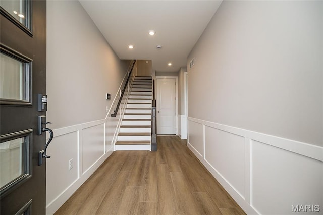 8915 E Gateway Hts Unit 94-803, Richmond Heights, MO 63144 - foyer featuring wood finished floors, stairway, recessed lighting, a decorative wall, and wainscoting