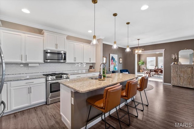 2385 Chemin Ave, Saint Charles, MO 63301 - kitchen with stainless steel appliances, white cabinets, tasteful backsplash, dark wood-type flooring, and recessed lighting