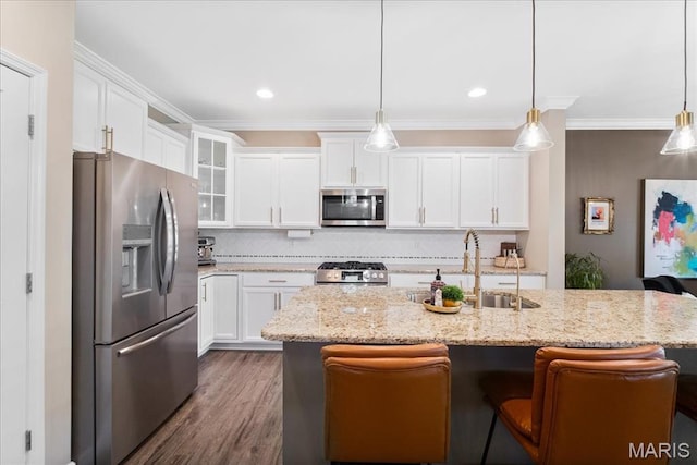 2385 Chemin Ave, Saint Charles, MO 63301 - kitchen with stainless steel appliances, white cabinets, tasteful backsplash, a breakfast bar area, and ornamental molding