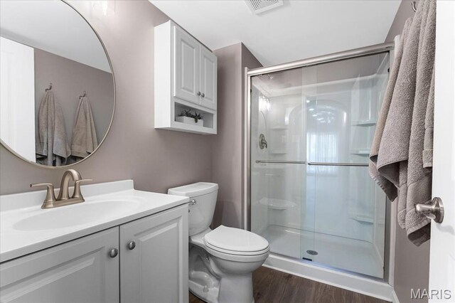 2385 Chemin Ave, Saint Charles, MO 63301 - bathroom featuring a stall shower, vanity, and wood finished floors