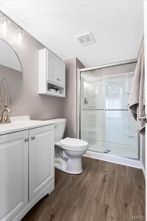 2385 Chemin Ave, Saint Charles, MO 63301 - full bathroom featuring wood finished floors, vanity, and a shower stall