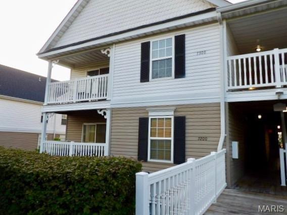 7302 Spring Creek Ln, Ofallon, MO 63368 - rear view of house with a balcony