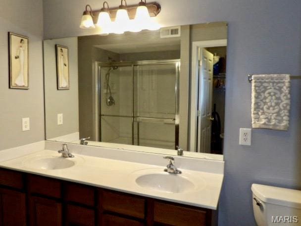 7302 Spring Creek Ln, Ofallon, MO 63368 - bathroom featuring double vanity and a stall shower