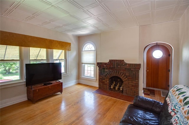 301 E 7th St, Alton, IL 62002 - living room with light wood-style floors, a fireplace, arched walkways, and an ornate ceiling