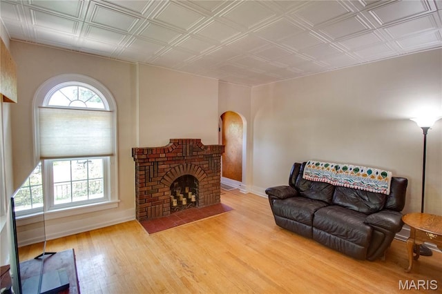 301 E 7th St, Alton, IL 62002 - living room with arched walkways, wood finished floors, an ornate ceiling, and a brick fireplace