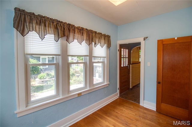 301 E 7th St, Alton, IL 62002 - unfurnished room featuring light wood-style flooring and arched walkways
