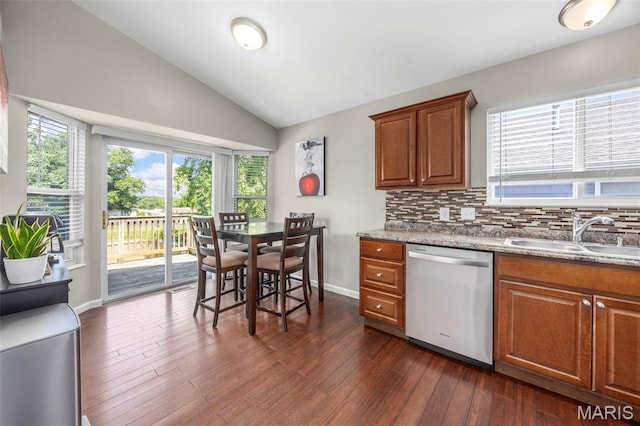 33 Kingspointe Dr, Saint Peters, MO 63376 - kitchen featuring stainless steel dishwasher, brown cabinets, decorative backsplash, vaulted ceiling, and dark wood finished floors