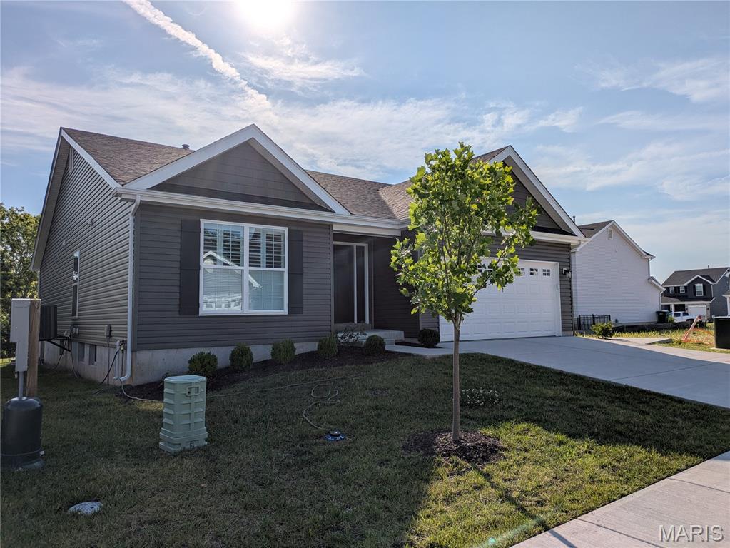 3309 White Pine Dr, Imperial, MO 63052 - view of front of home with a garage, driveway, a front yard, and roof with shingles