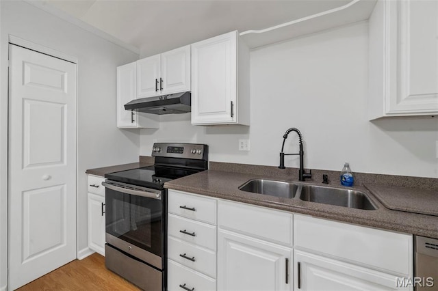 5265 Country Club Rd, Washington, MO 63090 - kitchen featuring appliances with stainless steel finishes, under cabinet range hood, dark countertops, and white cabinetry