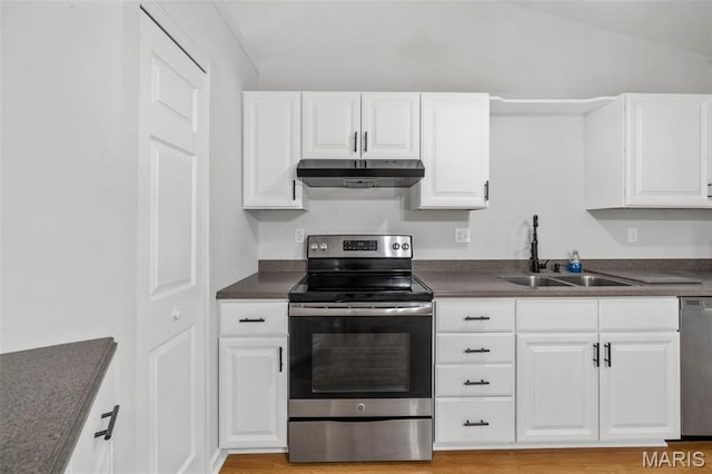 5265 Country Club Rd, Washington, MO 63090 - kitchen featuring appliances with stainless steel finishes, under cabinet range hood, dark countertops, white cabinets, and light wood finished floors