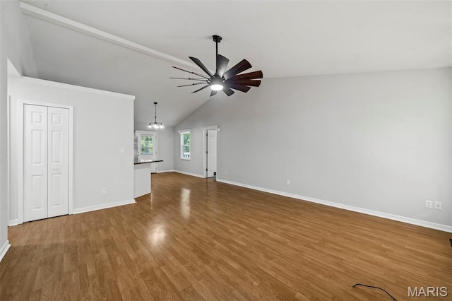5265 Country Club Rd, Washington, MO 63090 - unfurnished living room with a chandelier, a ceiling fan, wood finished floors, and lofted ceiling