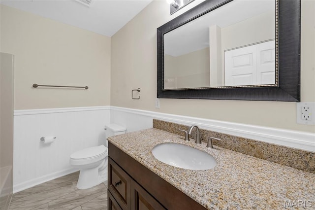 5265 Country Club Rd, Washington, MO 63090 - full bathroom with vanity, a wainscoted wall, marble look tiles, and a tub to relax in