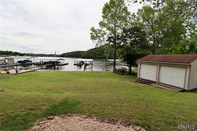 980 Laura Hufferd Rd, Roach, MO 65787 - view of grassy yard featuring a water view, a boat dock, a detached garage, and an outbuilding