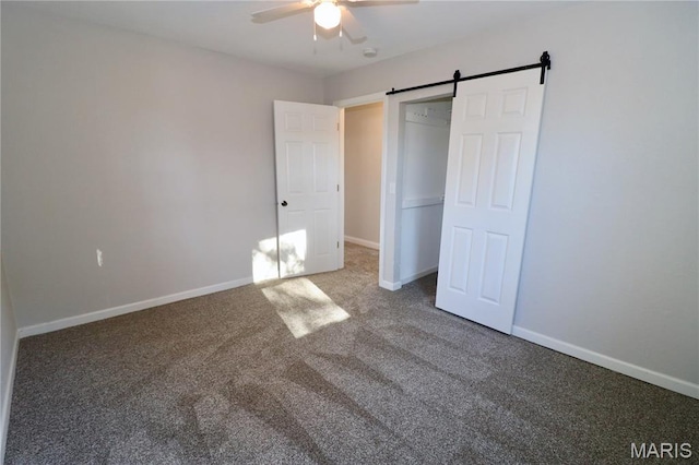 261 Buffalo Linn Creek Rd, Macks Creek, MO 65786 - unfurnished bedroom with carpet, a barn door, and a ceiling fan