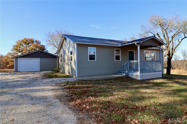 261 Buffalo Linn Creek Rd, Macks Creek, MO 65786 - view of front of property featuring driveway, a garage, an outbuilding, a metal roof, and a front lawn