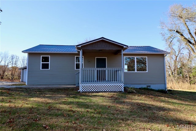 261 Buffalo Linn Creek Rd, Macks Creek, MO 65786 - view of front of house with covered porch, a front lawn, and a metal roof