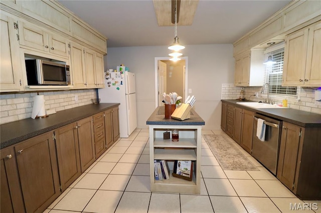 110 S Bend Rd, Lebanon, MO 65536 - kitchen with appliances with stainless steel finishes, dark countertops, tasteful backsplash, and light tile patterned flooring