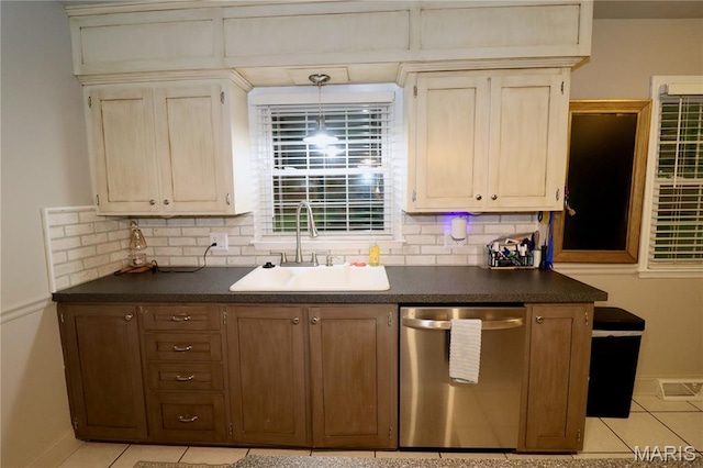 110 S Bend Rd, Lebanon, MO 65536 - kitchen with dishwasher, dark countertops, light tile patterned flooring, tasteful backsplash, and hanging light fixtures