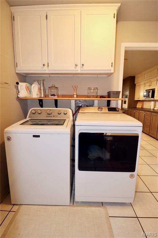 110 S Bend Rd, Lebanon, MO 65536 - laundry area featuring independent washer and dryer and light tile patterned floors