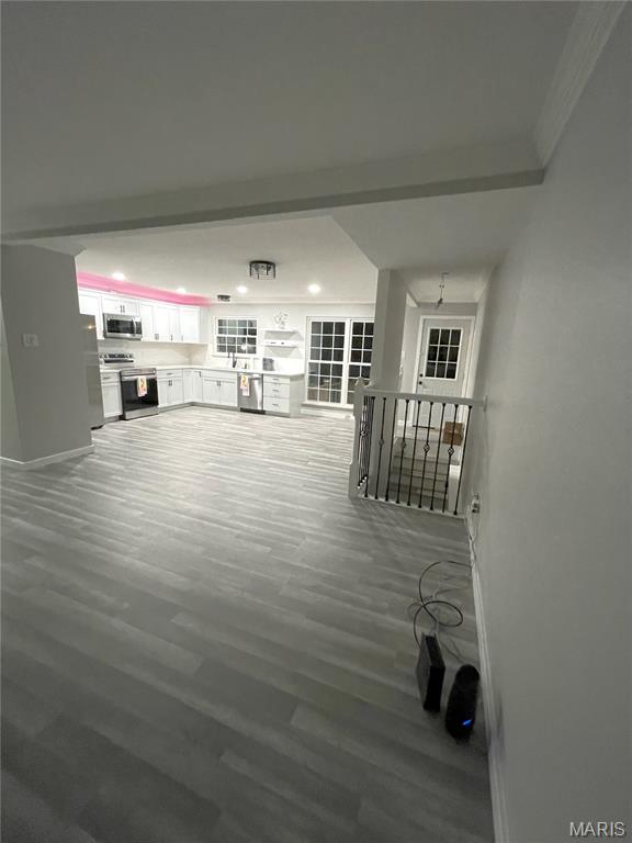 19 Saint David Dr, Saint Peters, MO 63376 - unfurnished living room featuring wood finished floors, crown molding, and recessed lighting