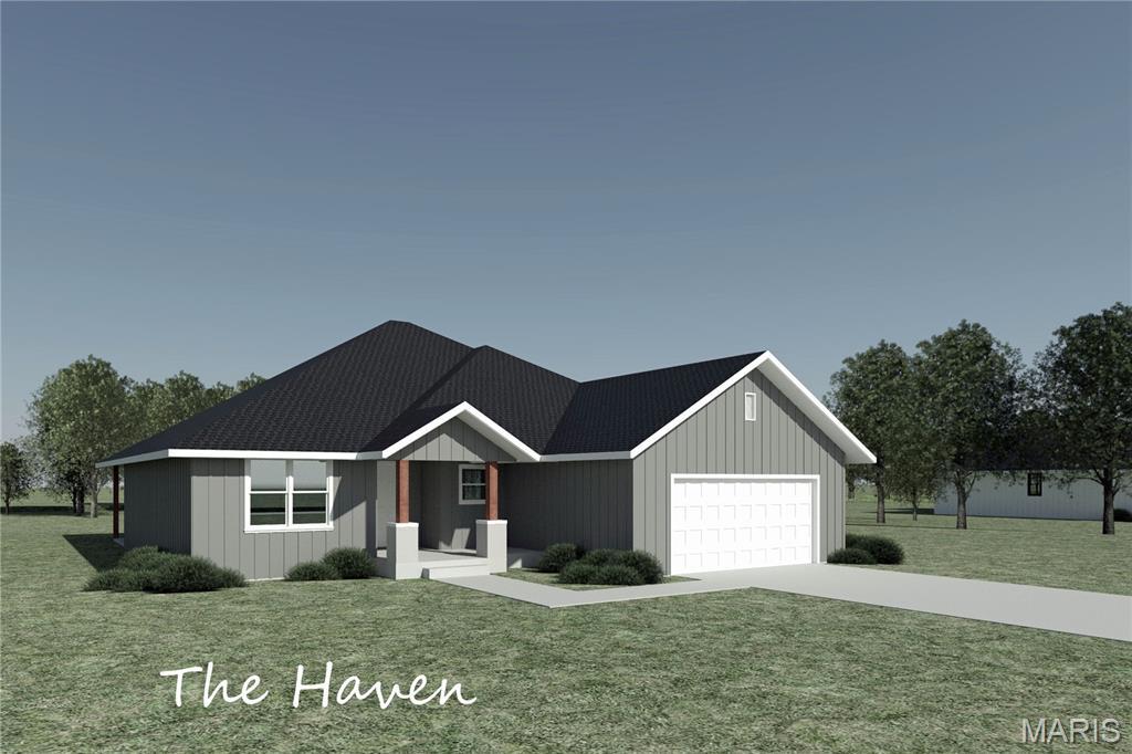 1801 Vadie Ave, Lebanon, MO 65536 - view of front of home featuring an attached garage, driveway, and a front lawn