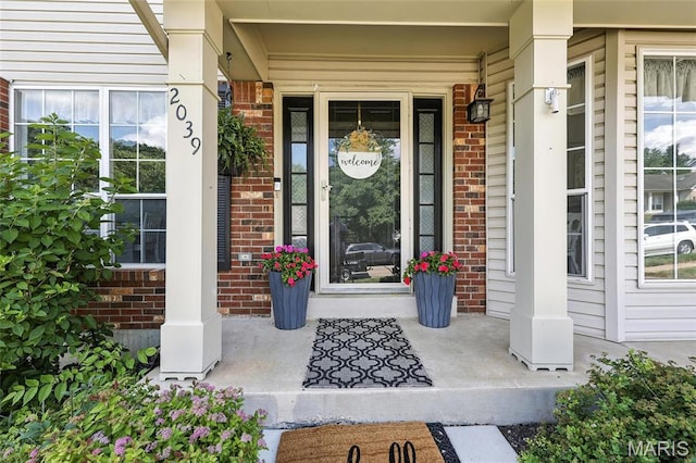2039 Meramec Meadows Dr, Fenton, MO 63026 - doorway to property featuring brick siding and a porch