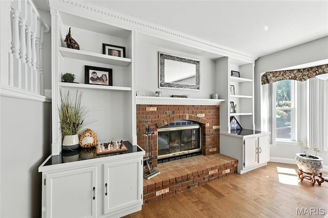 2039 Meramec Meadows Dr, Fenton, MO 63026 - living area with light wood-style floors, a fireplace, and built in features