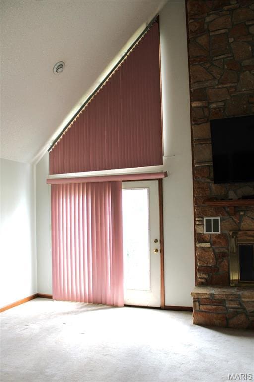 904 Keith St, Kennett, MO 63857 - unfurnished living room with a fireplace, carpet, lofted ceiling, and healthy amount of natural light