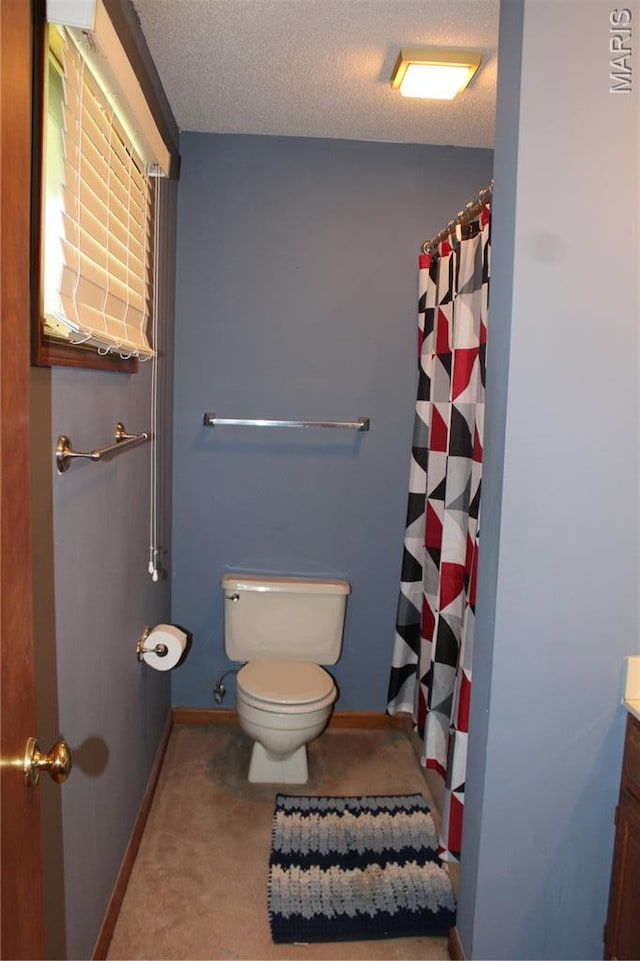 904 Keith St, Kennett, MO 63857 - full bathroom featuring vanity, a textured ceiling, and a shower with shower curtain