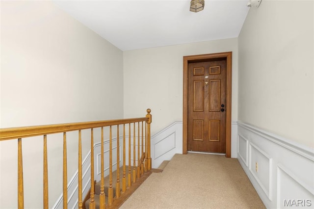 115 E Bodley Ave Unit A6, Kirkwood, MO 63122 - hallway featuring a decorative wall, wainscoting, carpet floors, and an upstairs landing