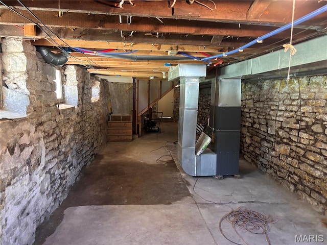 2012 Mallinckrodt St, Saint Louis, MO 63107 - unfinished basement with heating unit and stairs