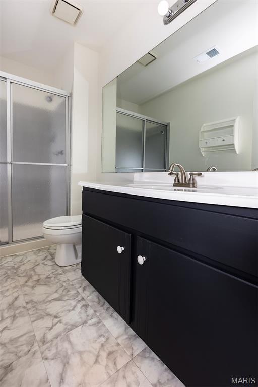 1316 Holgate Unit G6, Ballwin, MO 63021 - bathroom with vanity, marble look tiles, and a shower stall